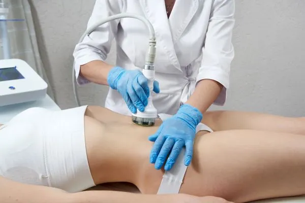 Lost the Weight but Not the Loose Skin? 2 woman having HIFU treatment on her stomach to combat loose skin Dunstable following weight loss
